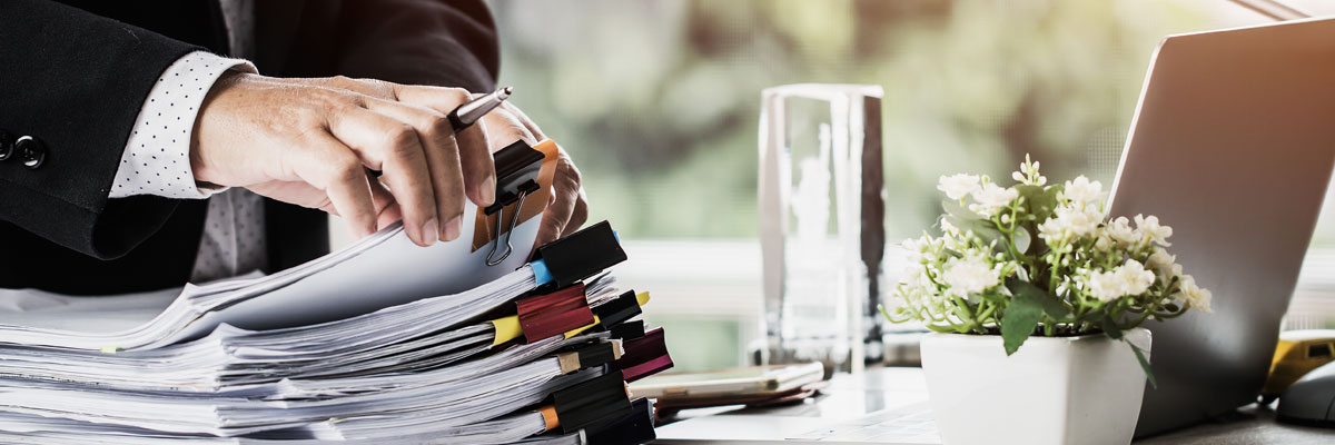 Businessman with contracts and laptop