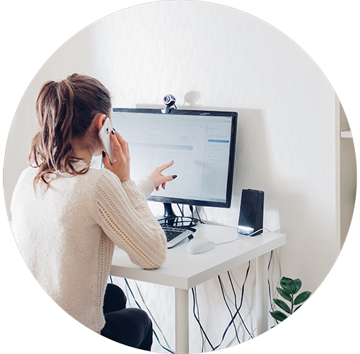 Female at a desk with computer taking a phone call