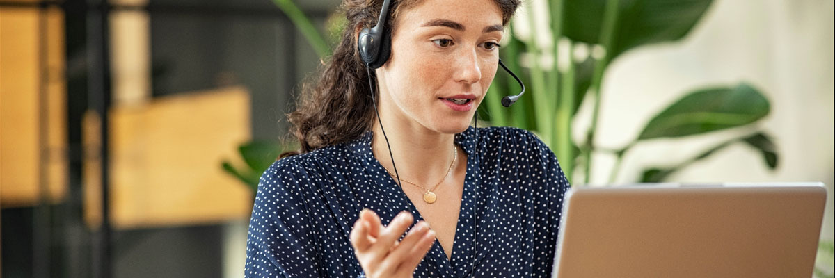 Customer support female with headset and laptop